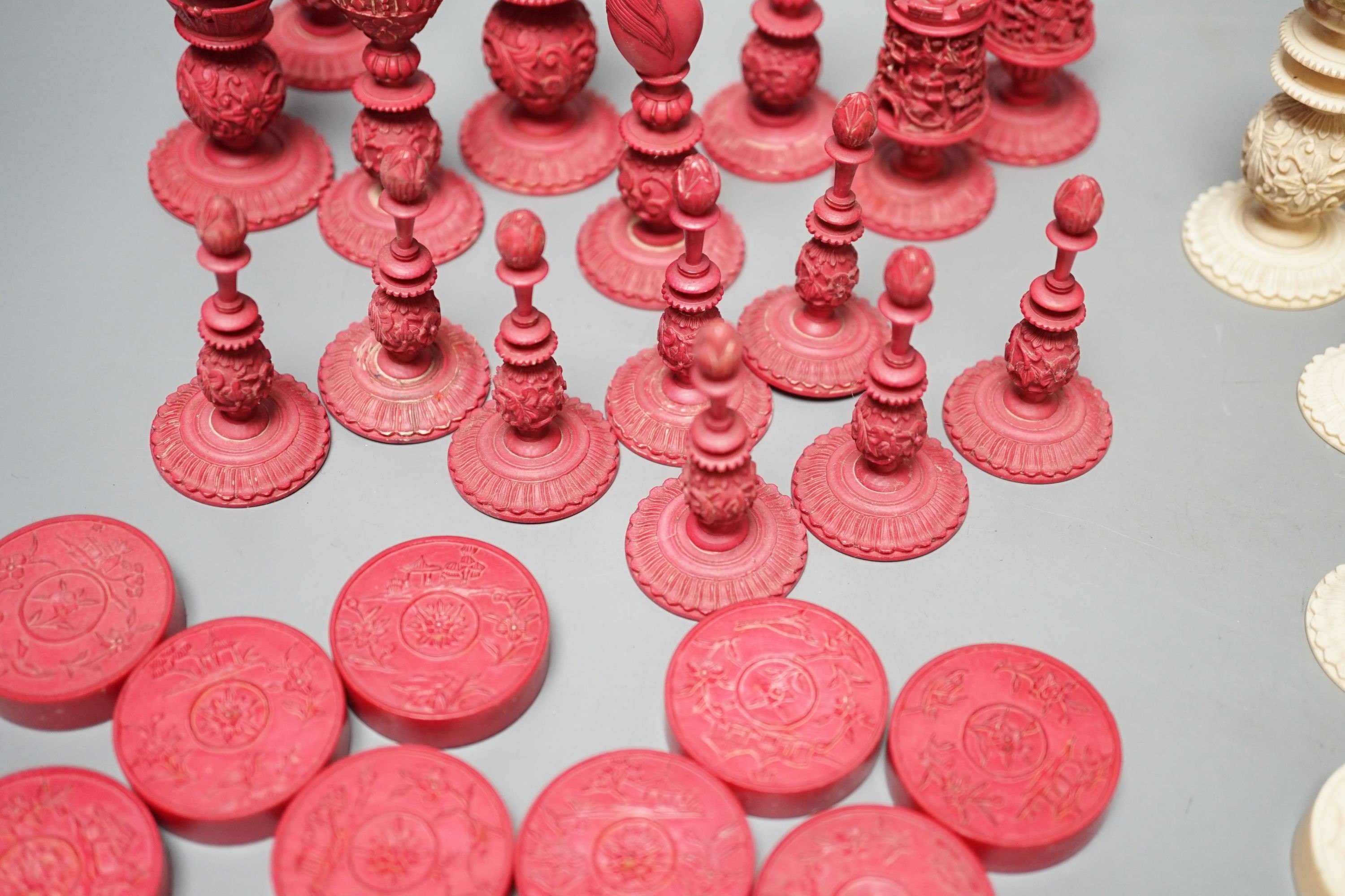 A 19th century Chinese export Burmese pattern carved and stained ivory chess set, one white pawn associated